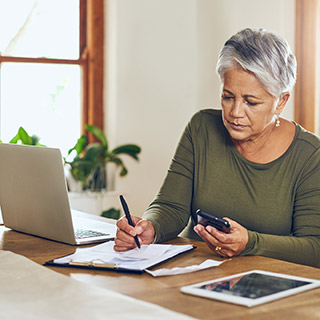 woman working on her laptop and mobile device