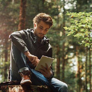Man using tablet in woods