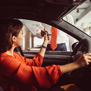 Woman getting keys to new car