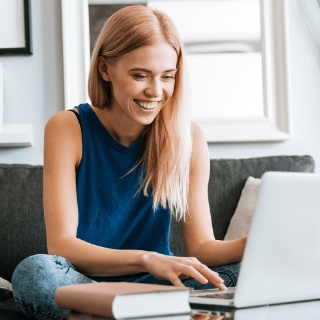 a woman sitting in front of her laptop