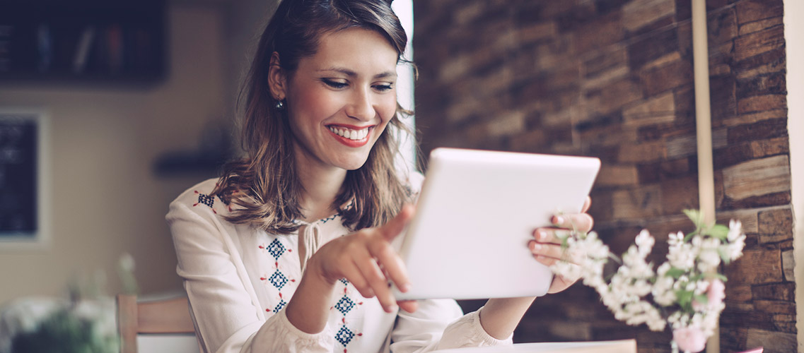 Woman looking at tablet in living room