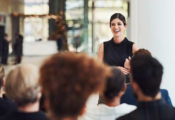 woman speaking in front of an audience