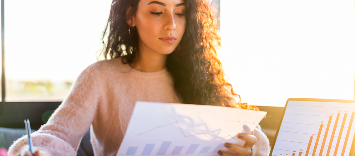 Young woman going over sales figures