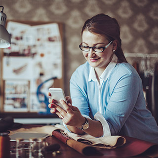 Woman using phone at place of business