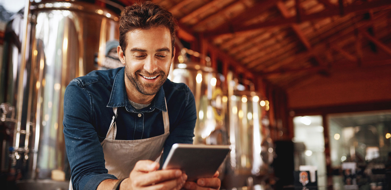 Young business owner looking at tablet